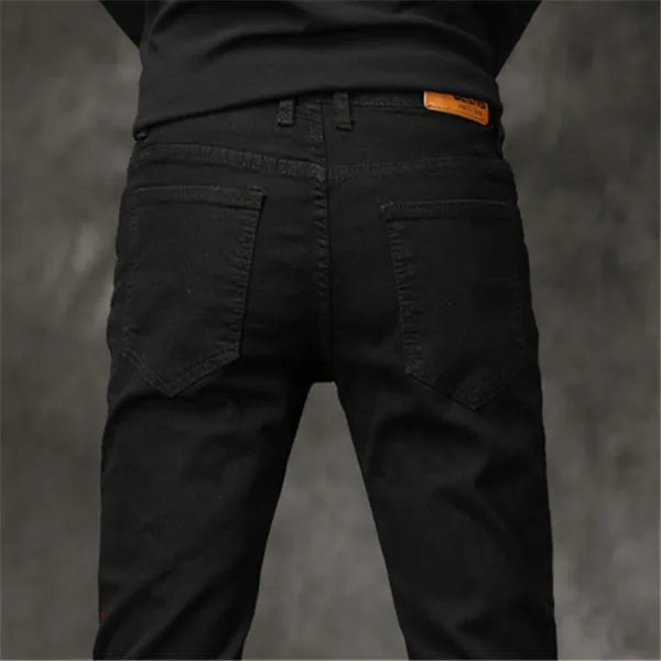 Slim-fit stretch cotton men's pants in black, laid flat showing tight cut and full length