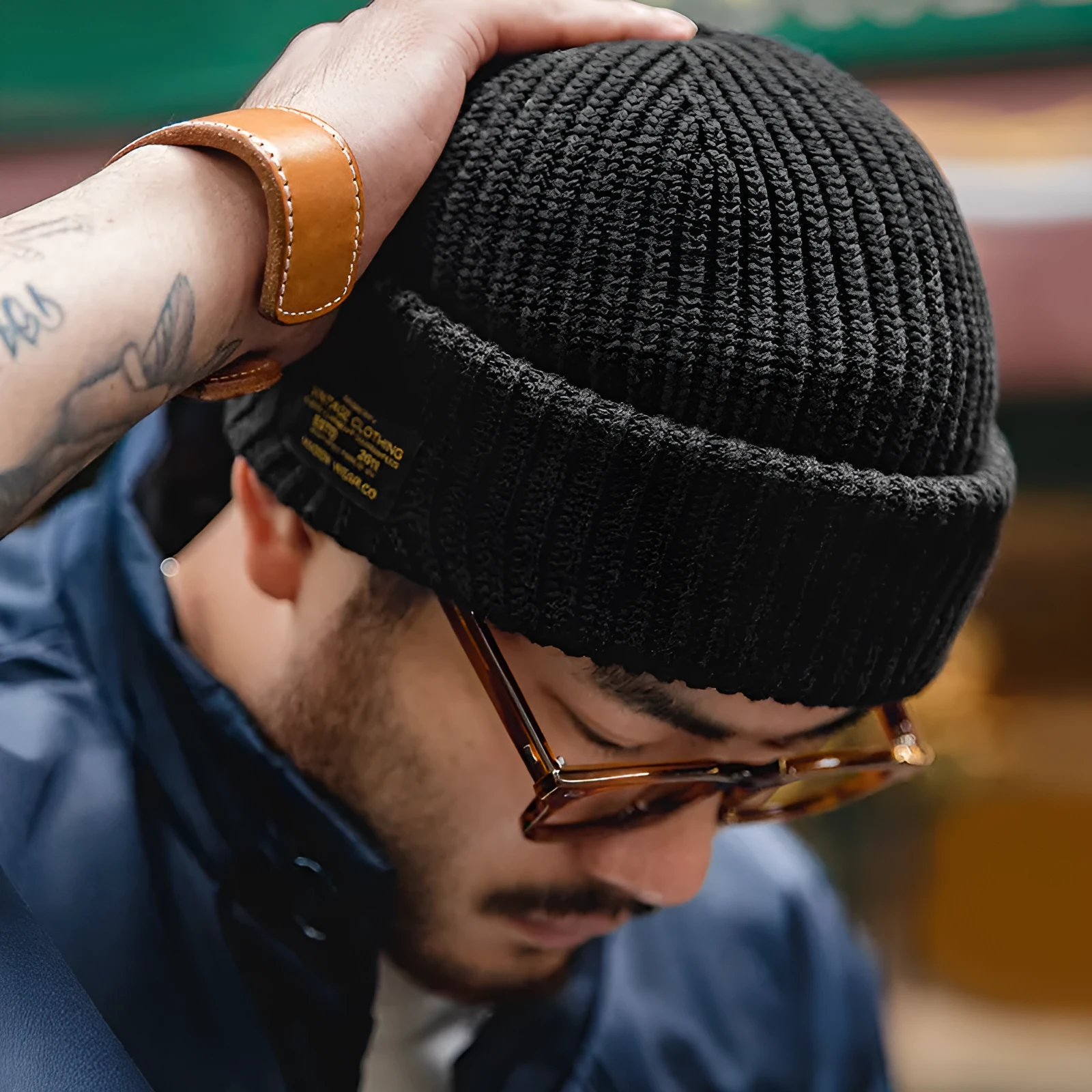 Vintage knitted melon-skin warm beanie in black with street-style patch detail, adjustable size, unisex design.
