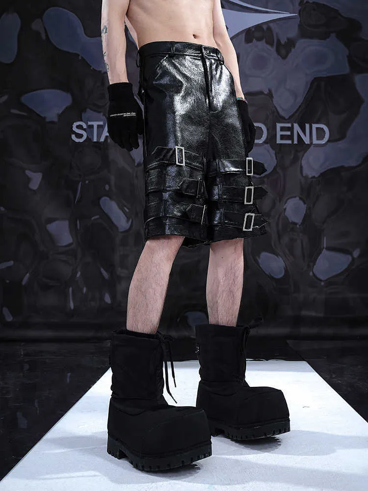 Black men's PU leather casual shorts with ring detailing, shown in a cropped pants style.