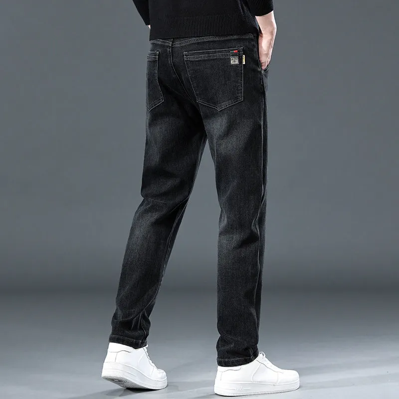 Blue grey men's slim straight casual trousers with a mid waist and zip fly on a neutral background.