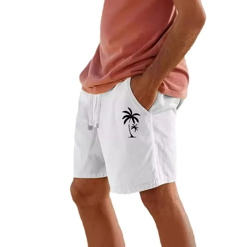 Men's beige shorts with green leaf print, featuring an elastic drawstring waistband.