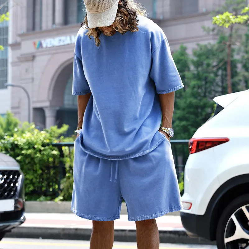 Men's casual sports suit set with grey round neck T-shirt and drawstring shorts on model
