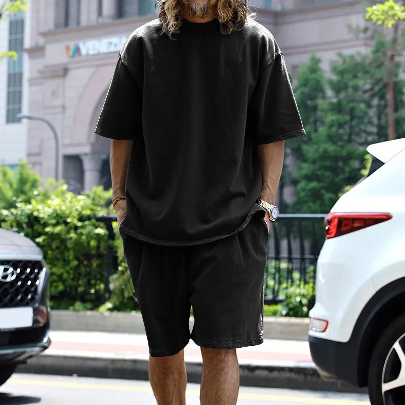 Men's casual sports suit set with grey round neck T-shirt and drawstring shorts on model
