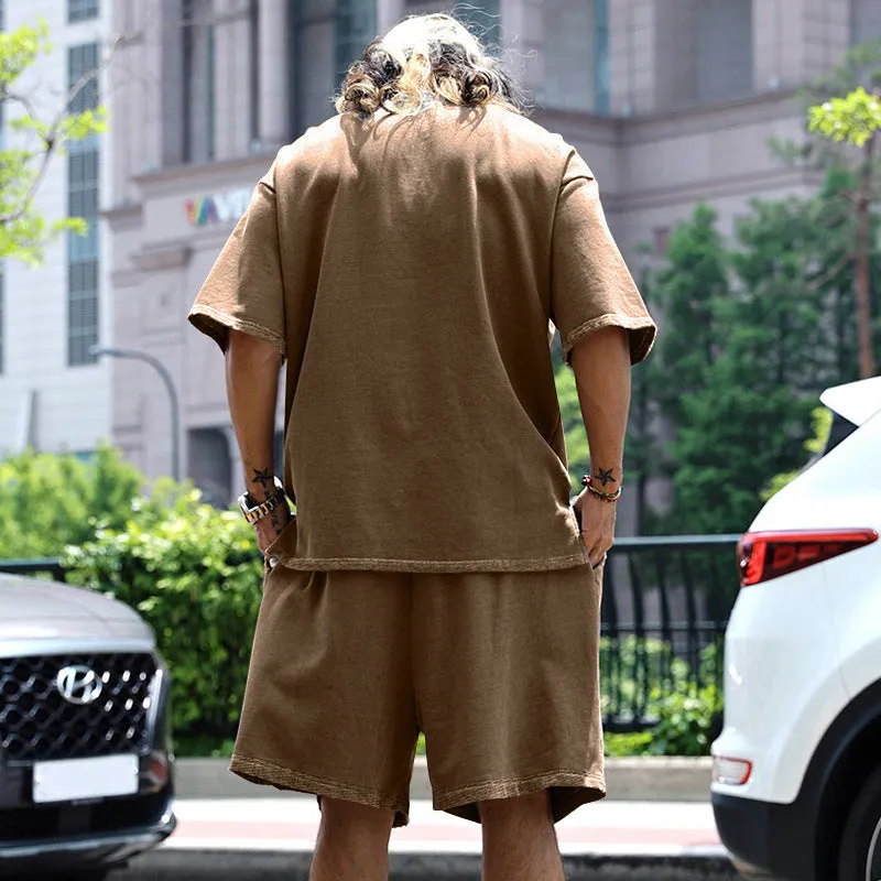 Men's casual sports suit set with grey round neck T-shirt and drawstring shorts on model