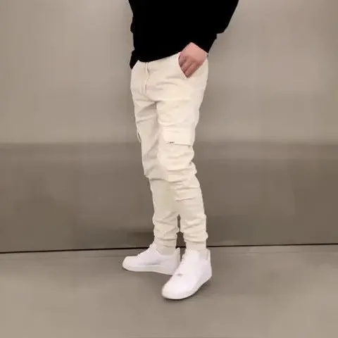 Man wearing loose-fit light blue casual trousers with a patch pocket and elasticated lace waistband