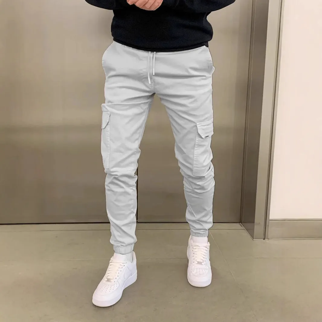 Man wearing loose-fit light blue casual trousers with a patch pocket and elasticated lace waistband