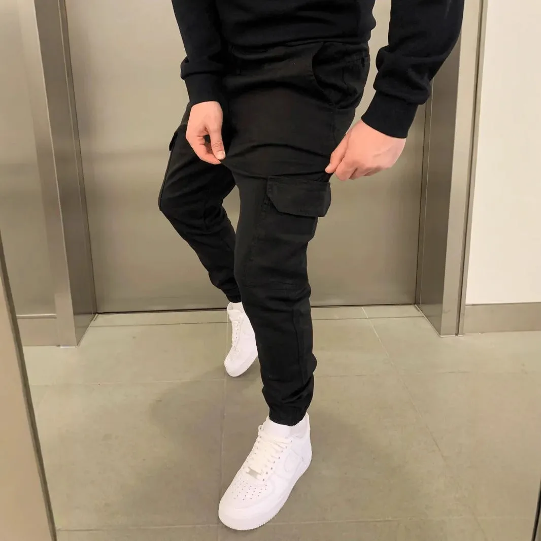 Man wearing loose-fit light blue casual trousers with a patch pocket and elasticated lace waistband