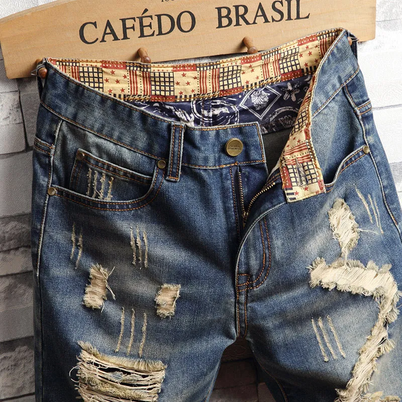 Men's blue denim capri shorts with big hole distressing, straight leg, zip fly, and mid-rise waist