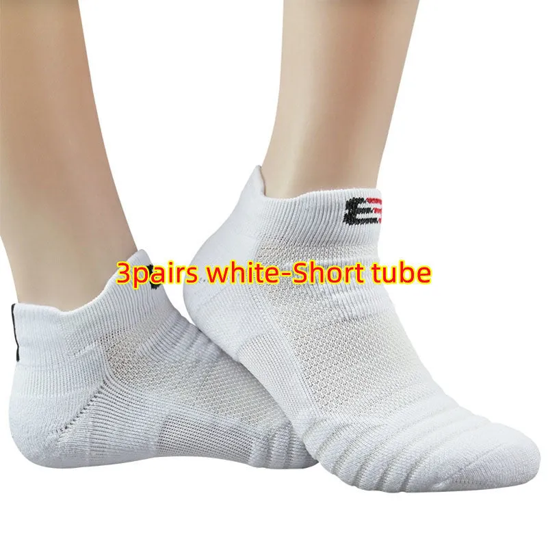 Three pairs of plain colour cotton blend socks in black, white, and grey
