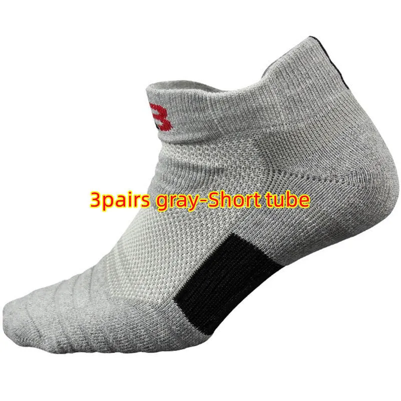 Three pairs of plain colour cotton blend socks in black, white, and grey