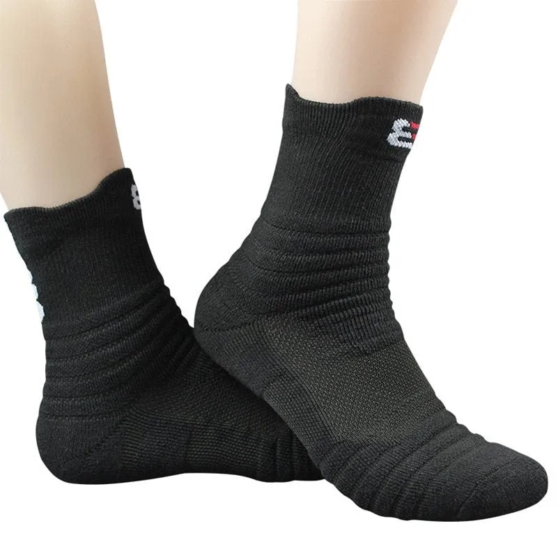 Three pairs of plain colour cotton blend socks in black, white, and grey
