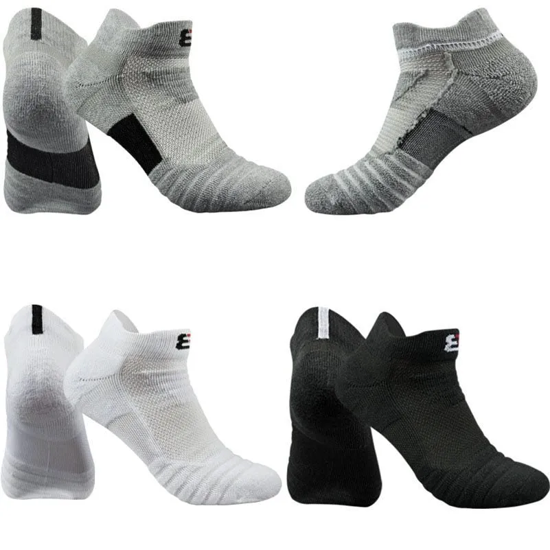 Three pairs of plain colour cotton blend socks in black, white, and grey