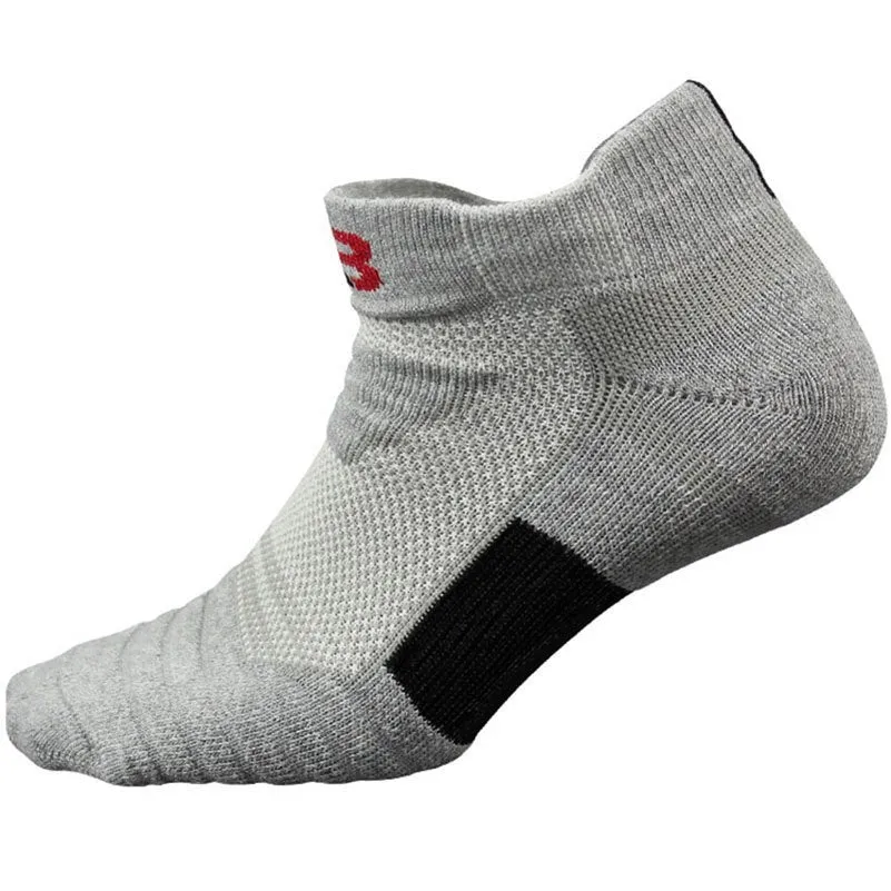 Three pairs of plain colour cotton blend socks in black, white, and grey