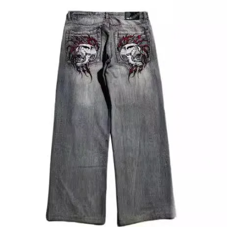 Gray washed-out denim jeans on a man, showing straight wide-leg cut and vintage workwear style.
