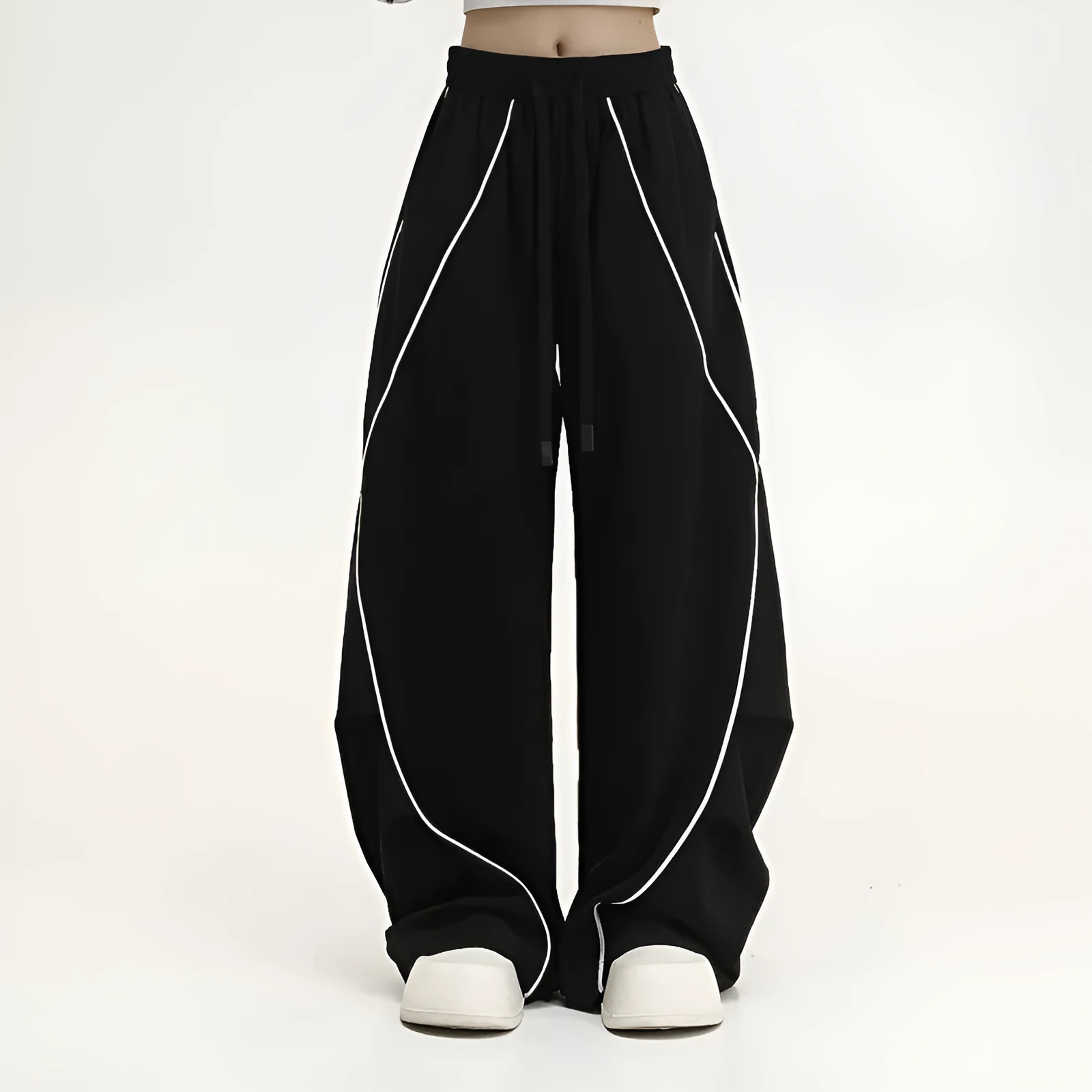 Black striped pleated wide-leg hip hop trousers laid flat, showing loose fit and mid waist.