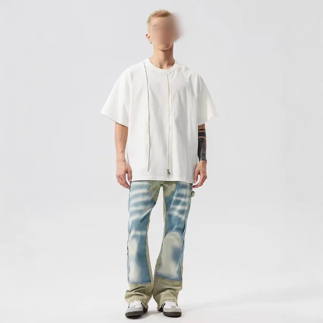 Yellow and blue retro patchwork jeans with splash-ink distressed design and zip fly.