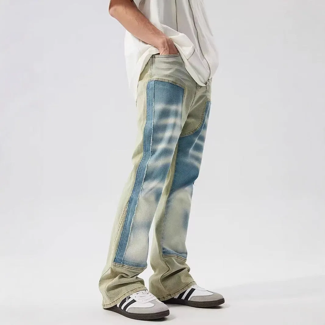Yellow and blue retro patchwork jeans with splash-ink distressed design and zip fly.