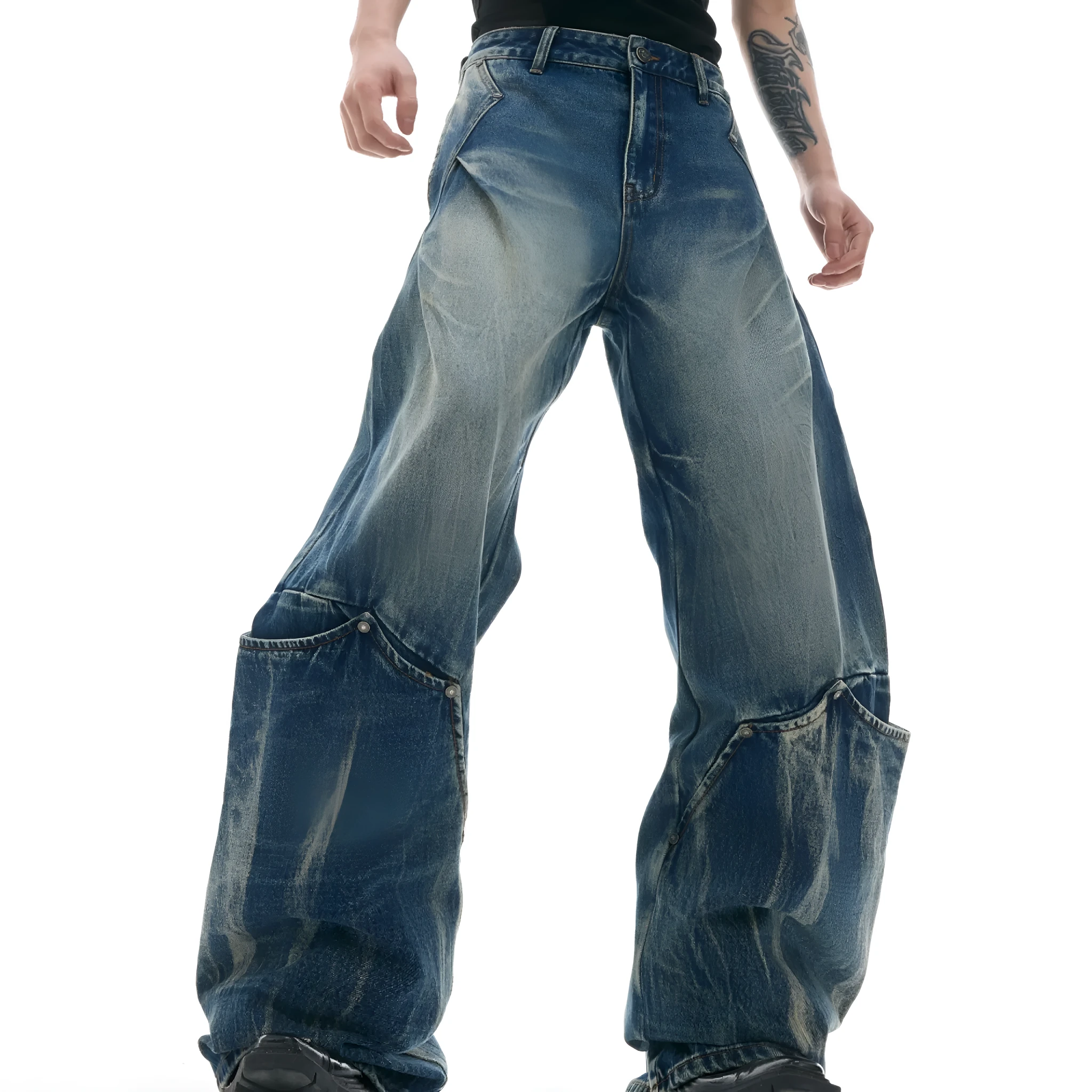 Man wearing verdant blue loose-fit retro jeans with a washed burst pattern.
