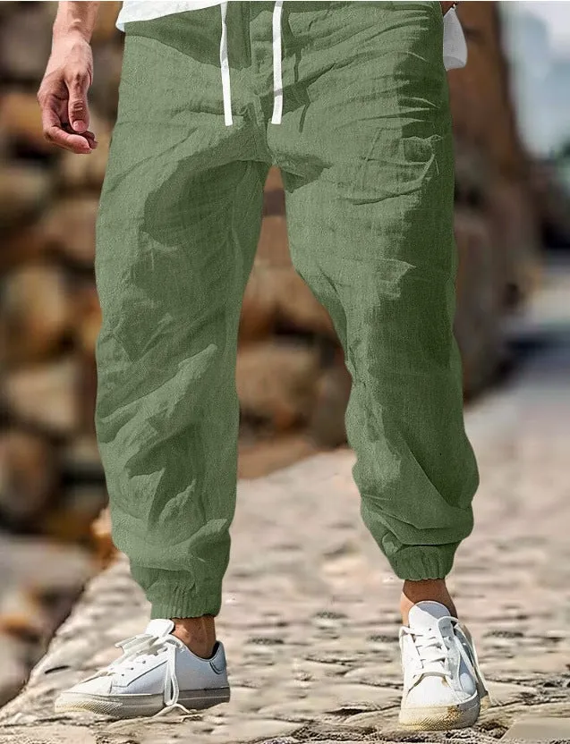 Men's straight-leg cotton trousers with elastic waist in apricot colour on a hanger