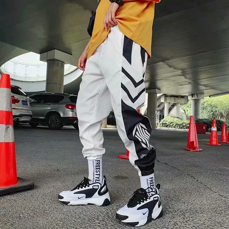 Men's hiphop trousers in black acetate fibre with tapered leg, side view