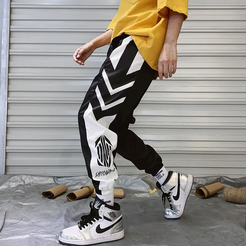 Men's hiphop trousers in black acetate fibre with tapered leg, side view