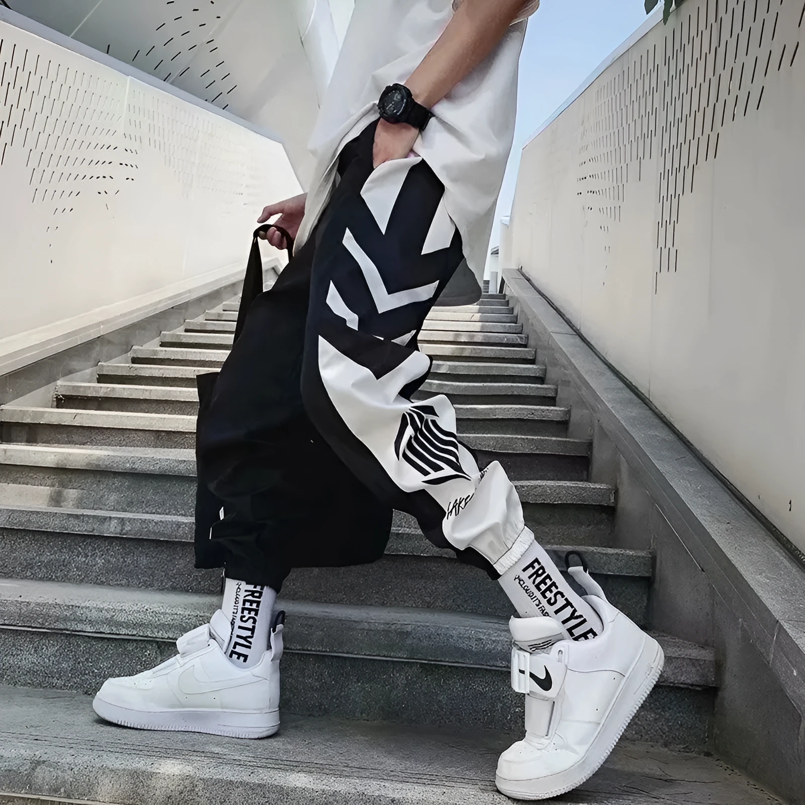 Men's hiphop trousers in black acetate fibre with tapered leg, side view
