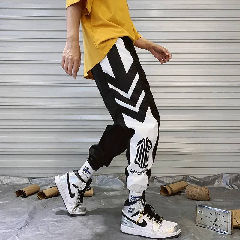 Men's hiphop trousers in black acetate fibre with tapered leg, side view