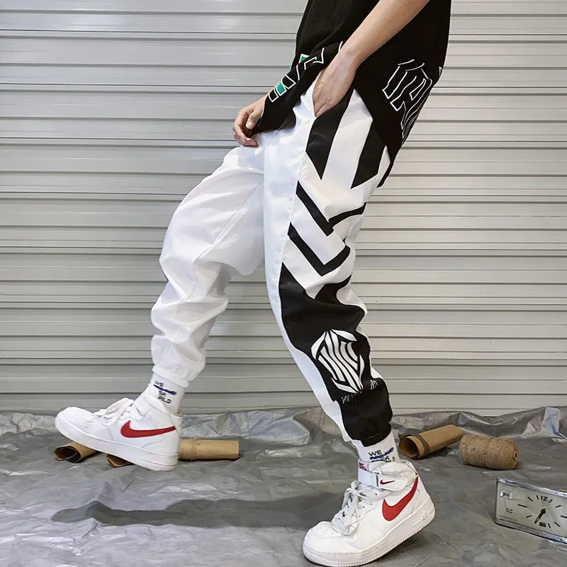 Men's hiphop trousers in black acetate fibre with tapered leg, side view