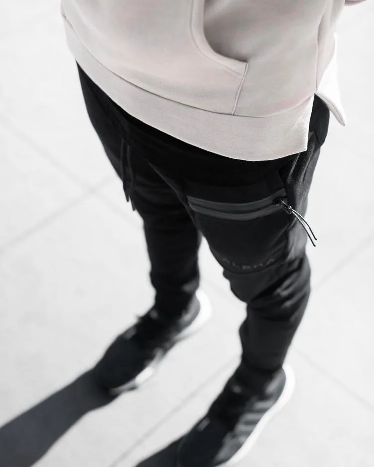 Men's black cotton joggers with elastic waist and velcro side pockets, loose fit, for sports and casual wear