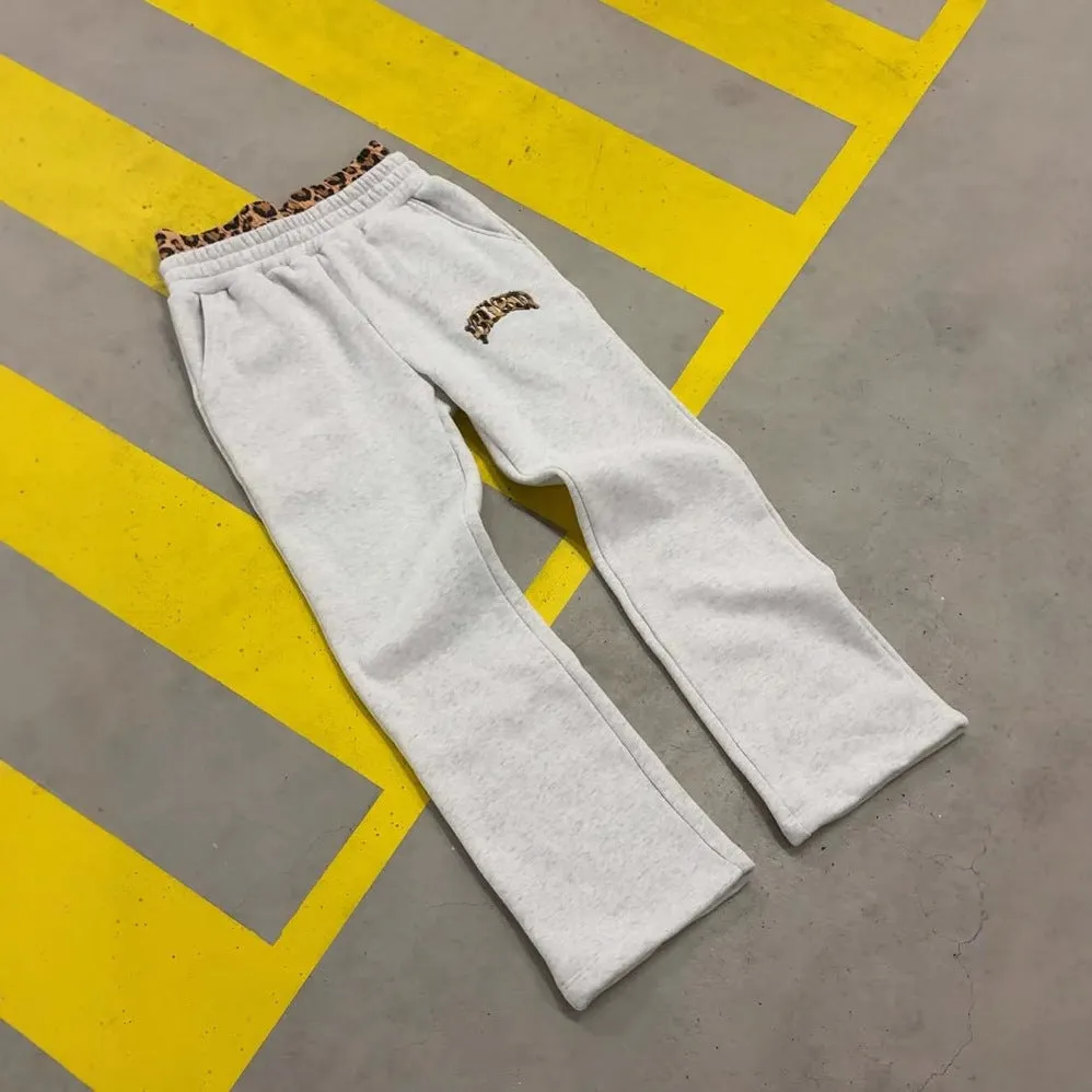 Man wearing grey patchwork double waist loose hip hop trousers for casual sports wear.