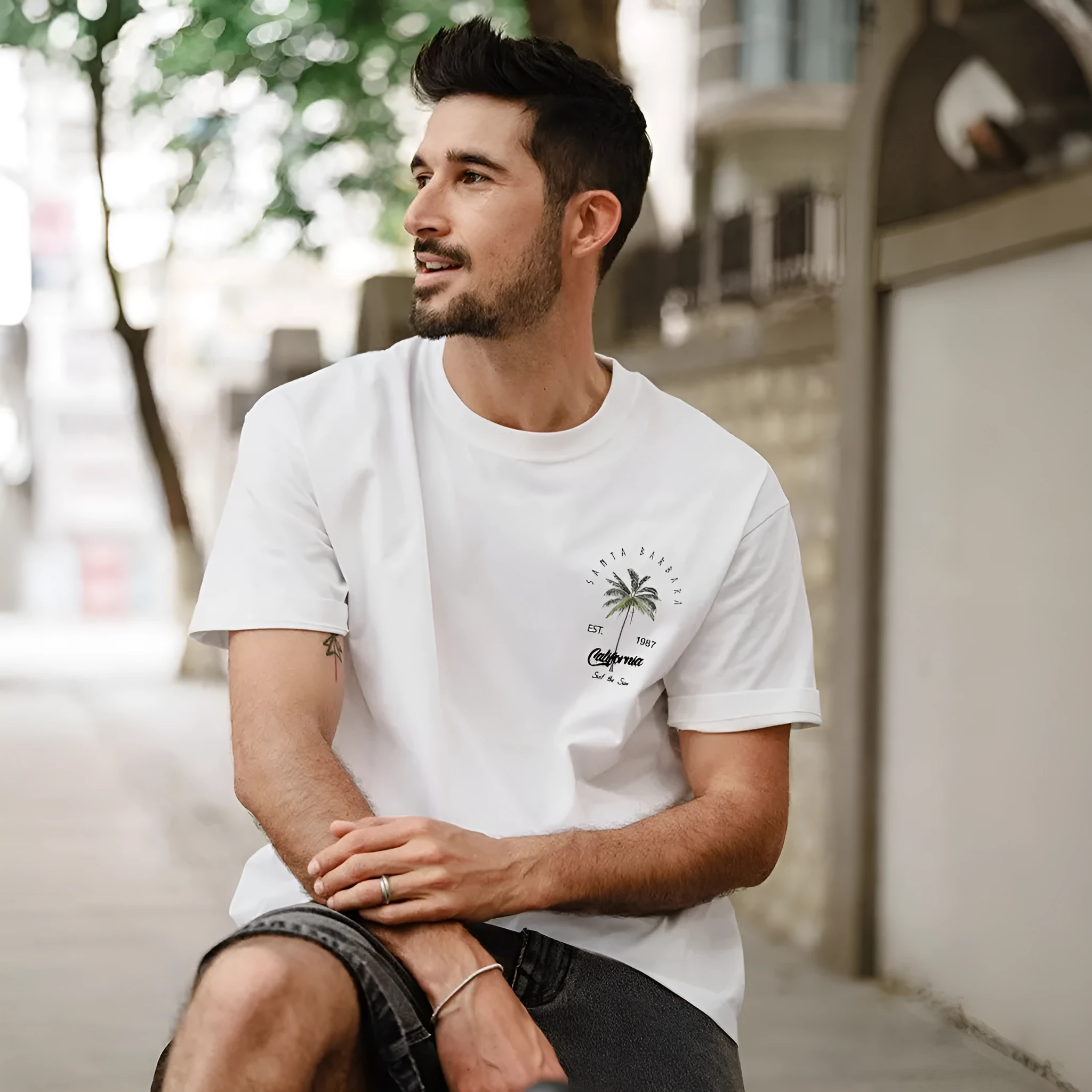 Men's white pure cotton loose fit cartoon print short sleeve t-shirt with black contrast pattern, front view