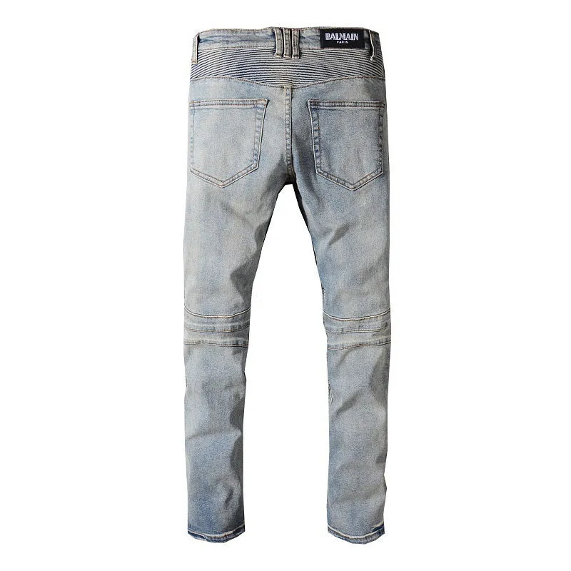 Grey biker jeans with straight tube leg, mid-rise waist, zipper fly, and distressed denim finish