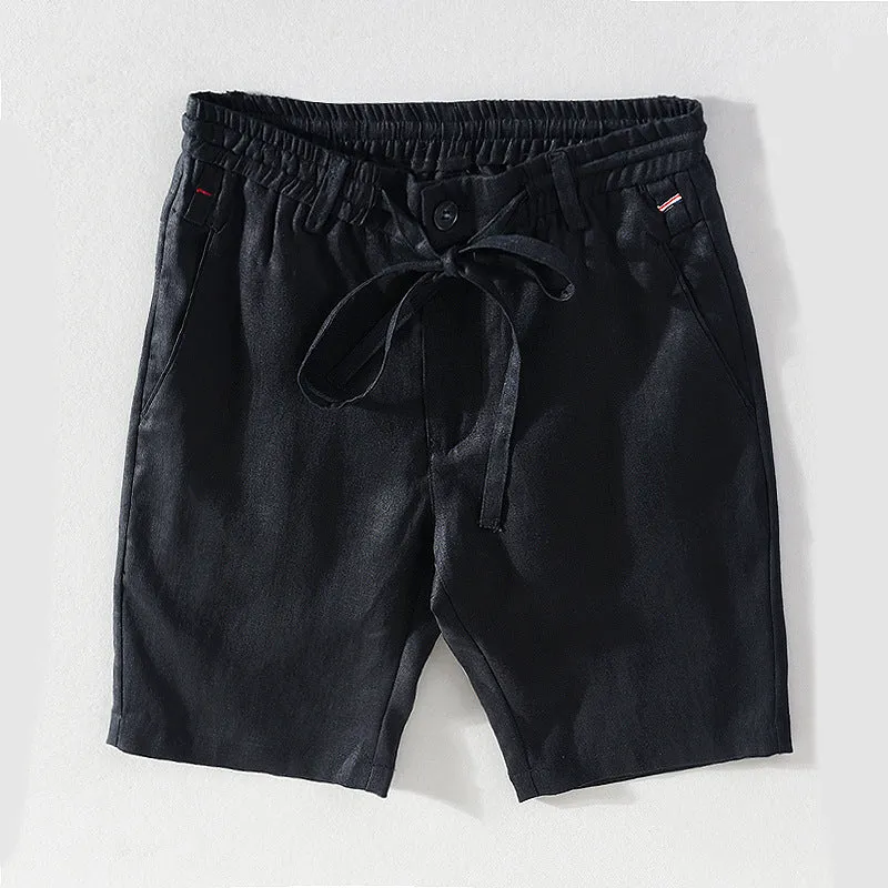 Men's 100% linen straight shorts in black, front view, mid-waist with zipper fly and pocket detail
