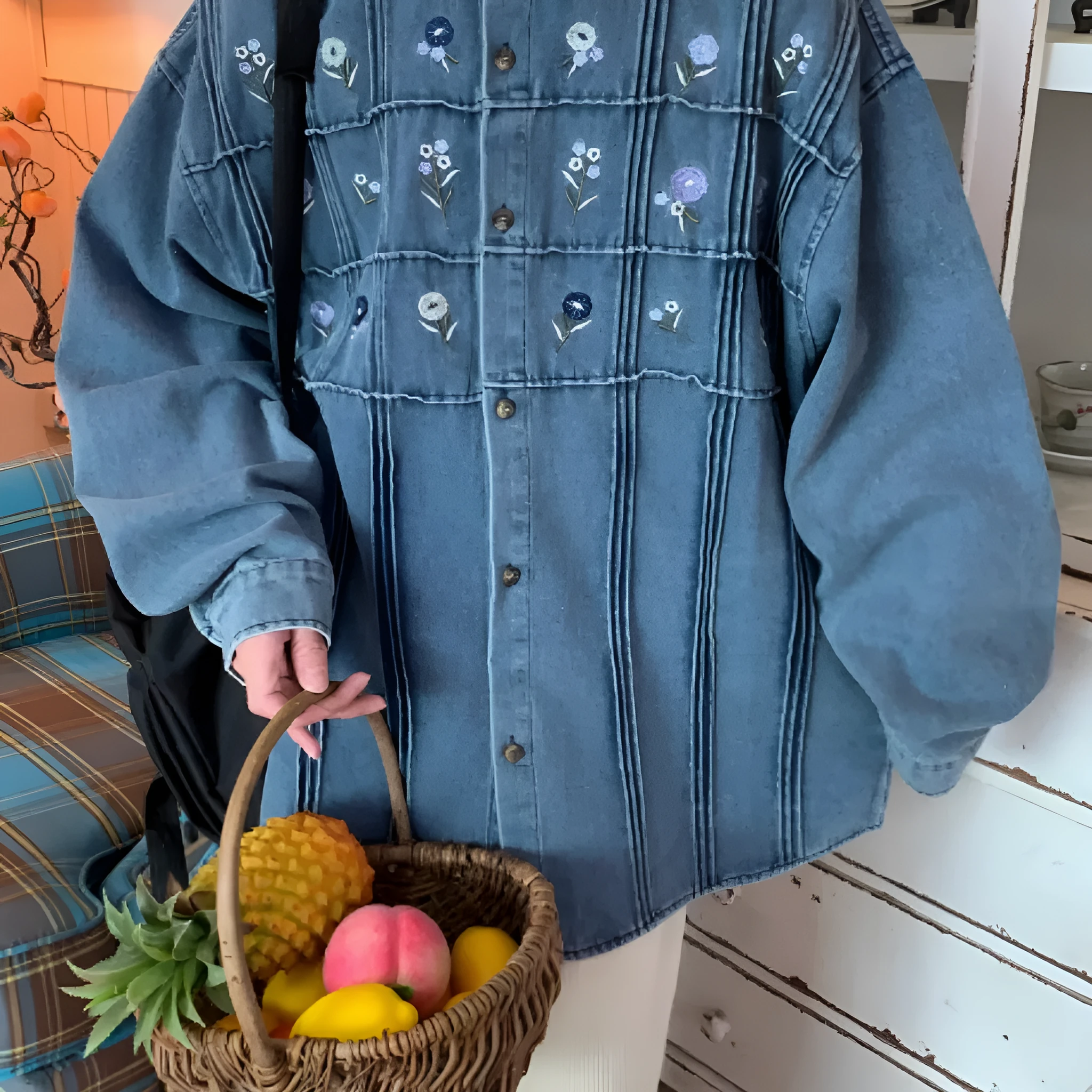 Washed blue long sleeved denim shirt with small floral pattern and pleated details on front