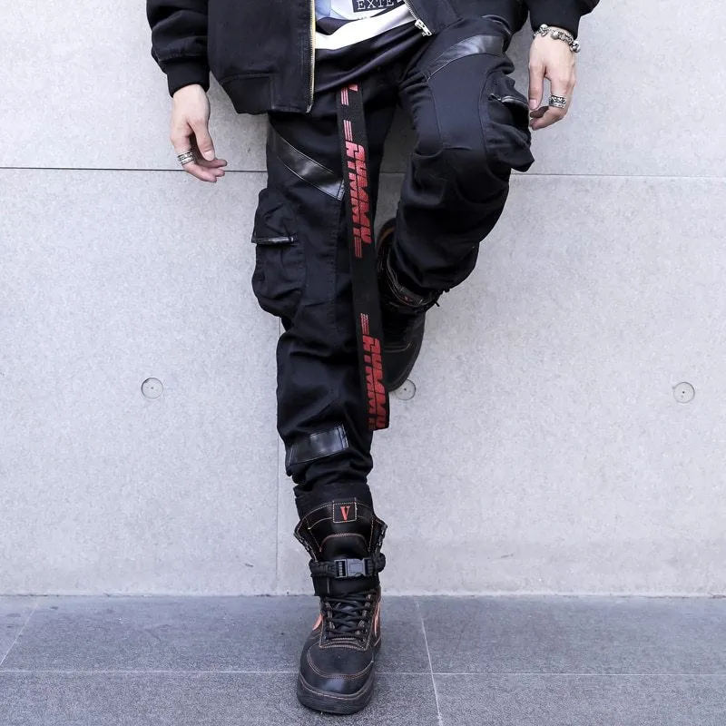 Black men's leather pocket splice cargo trousers with harem cut and long legs