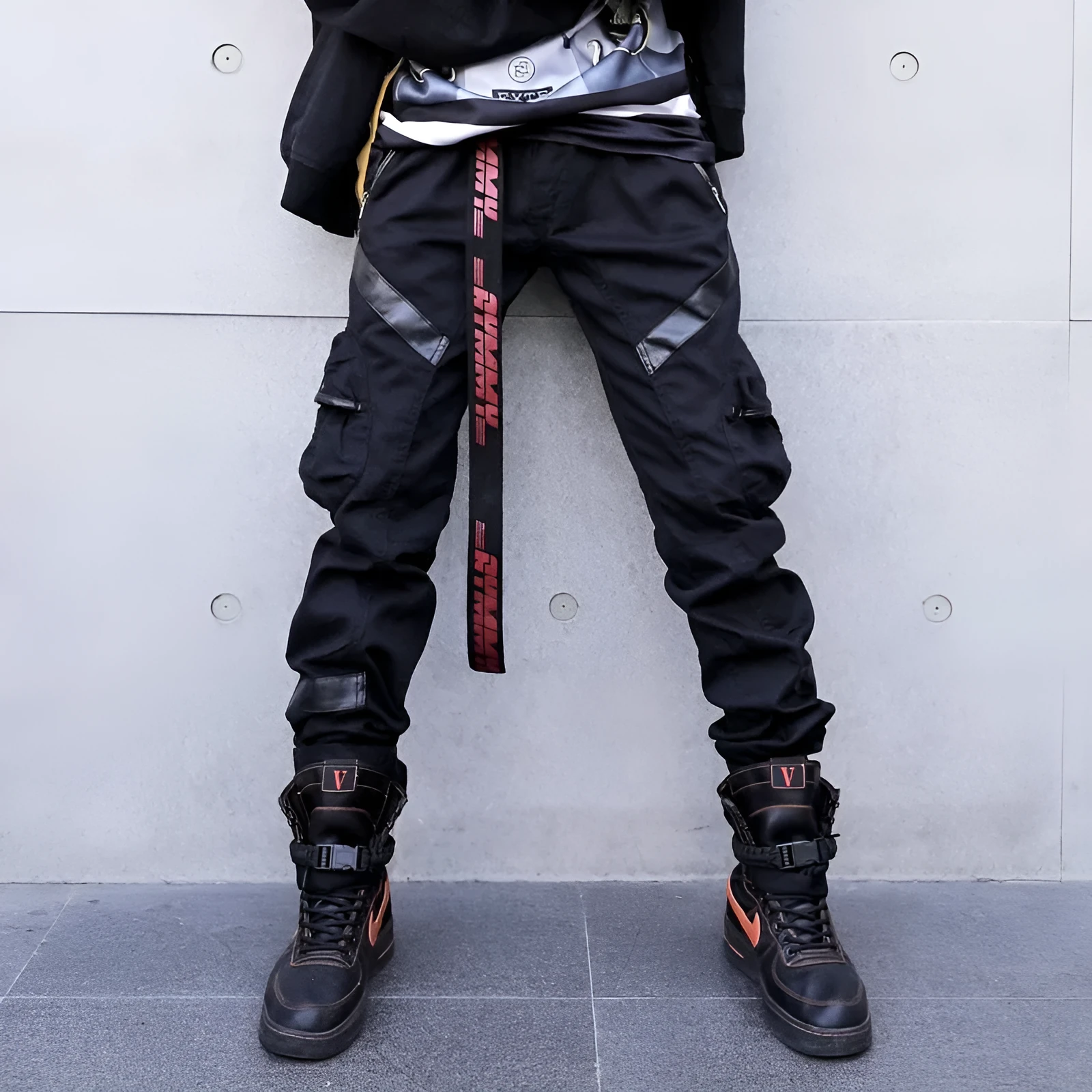 Black men's leather pocket splice cargo trousers with harem cut and long legs