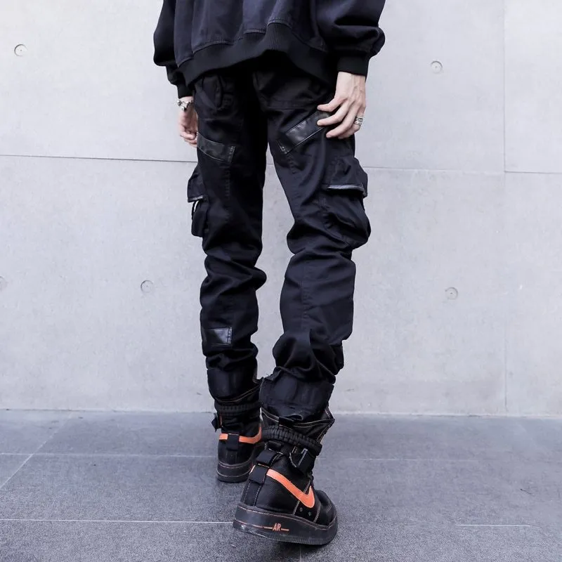 Black men's leather pocket splice cargo trousers with harem cut and long legs