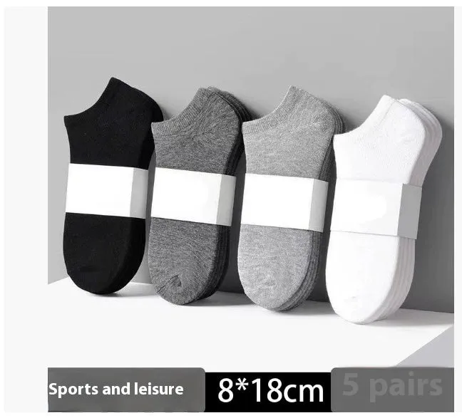 Solid colour men's low cut socks in black, grey, and white with seamless toe construction and blended fabric for breathability.