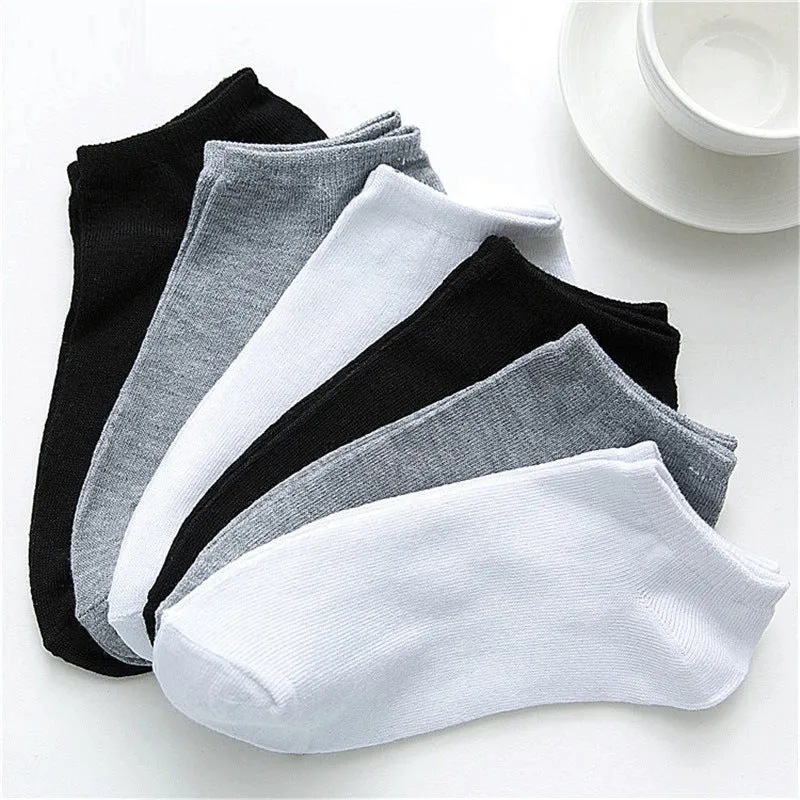 Solid colour men's low cut socks in black, grey, and white with seamless toe construction and blended fabric for breathability.