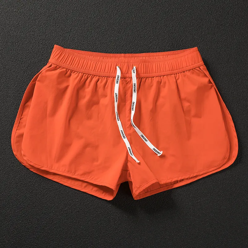 Men's loose polyester surfing shorts in orange, fluorescent green, or black on a size chart.
