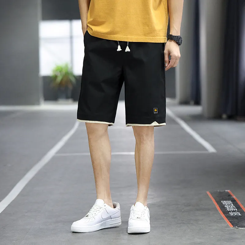 Man wearing loose-fitting straight-leg beach shorts in a khaki colour, showing Korean style and casual fit.