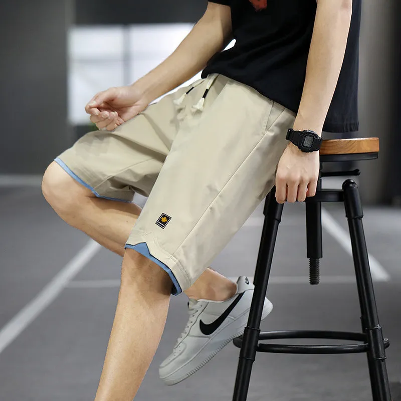 Man wearing loose-fitting straight-leg beach shorts in a khaki colour, showing Korean style and casual fit.