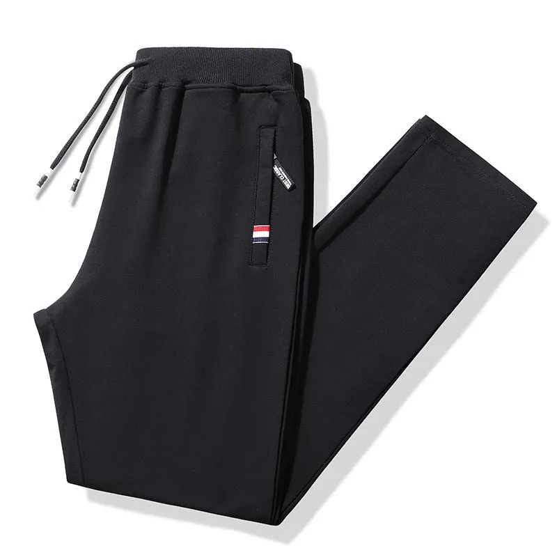 Pair of 95% cotton drawstring trousers in light grey, straight-leg nine-tenths length, laid flat on a plain background