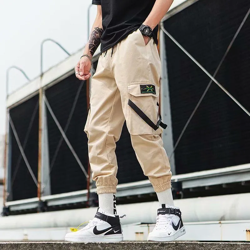 Hip hop jogger pants in khaki cotton fabric with elastic cuffs, shown flat