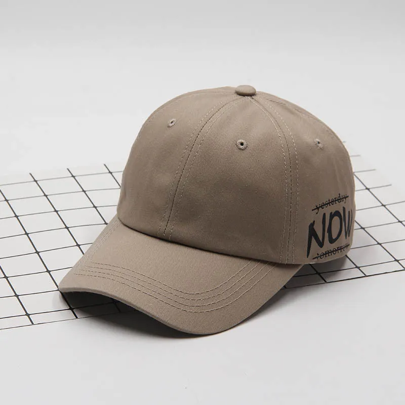 Cotton baseball cap with letter embroidery, adjustable back, curved brim, in beige on white background