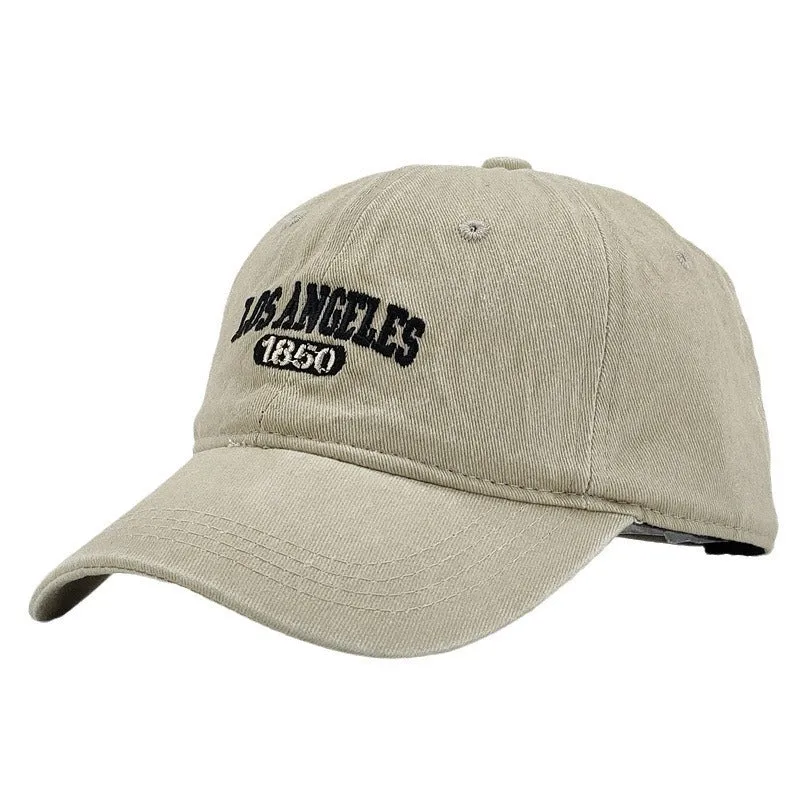 Retro style acrylic peaked cap with distressed letter embroidery on the front, shown in beige colour.