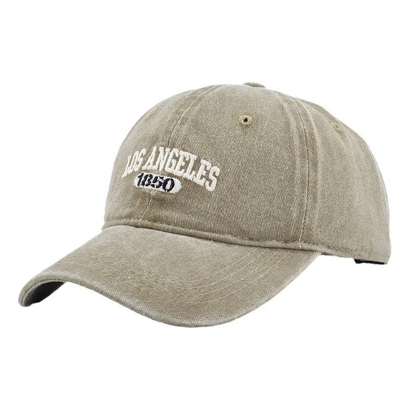Retro style acrylic peaked cap with distressed letter embroidery on the front, shown in beige colour.