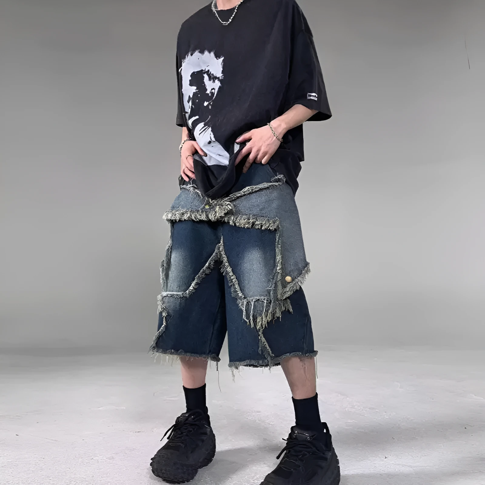 Blue denim shorts with frayed detailing and five-pointed star design in loose fit style