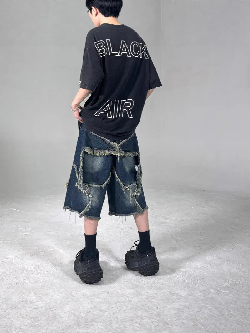 Blue denim shorts with frayed detailing and five-pointed star design in loose fit style