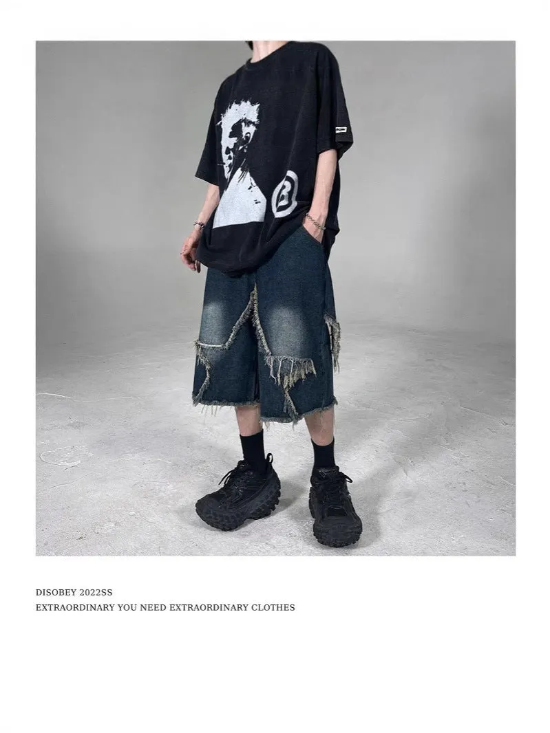 Blue denim shorts with frayed detailing and five-pointed star design in loose fit style